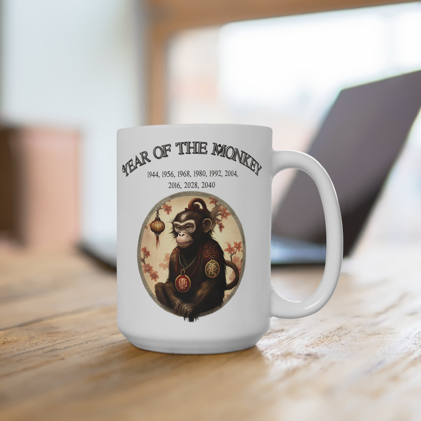 White mug with 'Year of the Monkey' design on a wooden surface