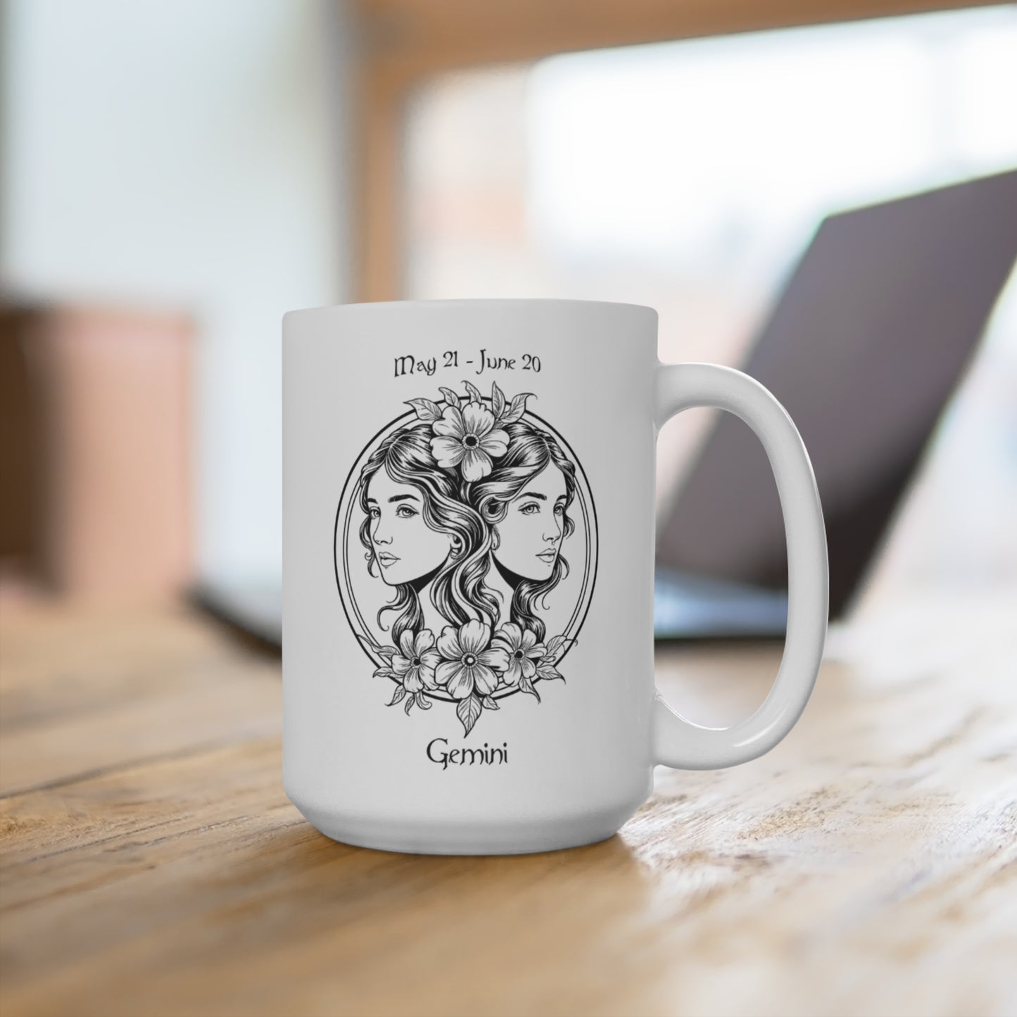White mug with Gemini zodiac design on a wooden surface