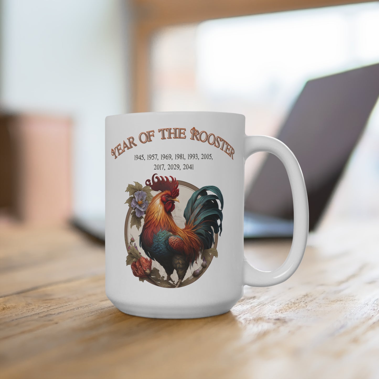 White mug with rooster design and 'Year of the Rooster' text on a wooden surface.