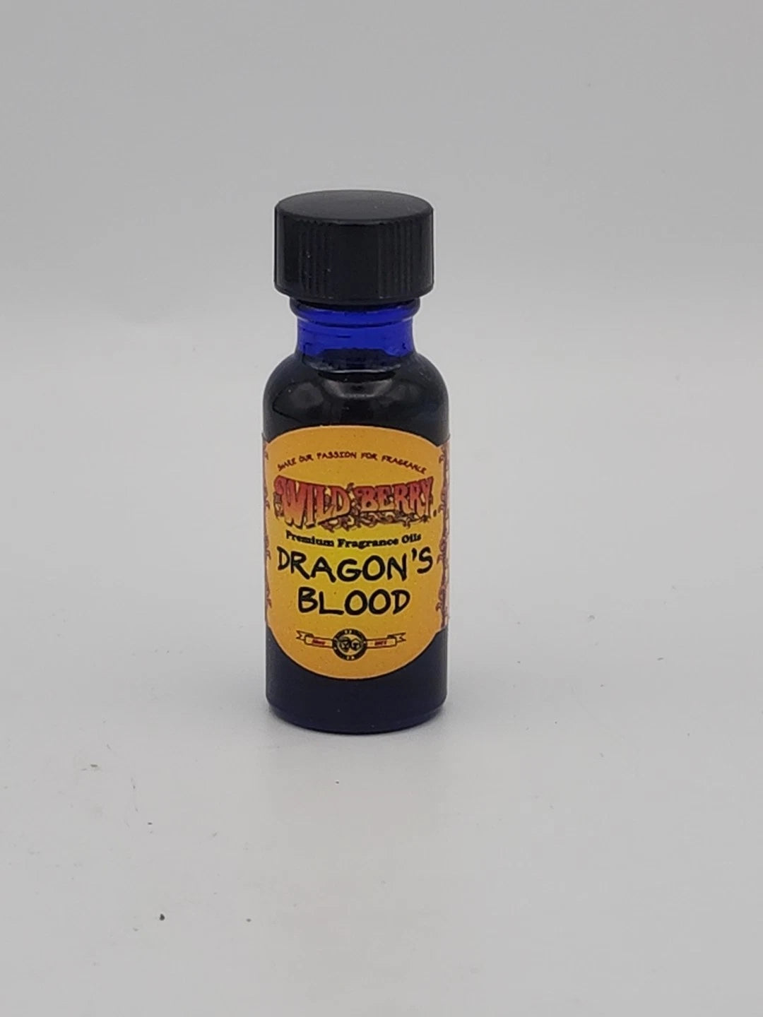 Small bottle labeled 'Dragon's Blood' on a gray background