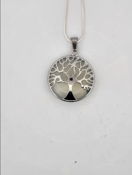 Silver tree of life pendant on a white background