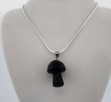 Black mushroom-shaped pendant on a silver chain displayed on a mannequin bust.