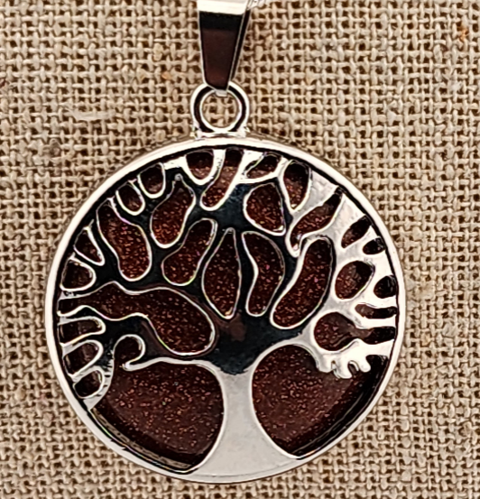 Tree of life pendant on a textured brown background