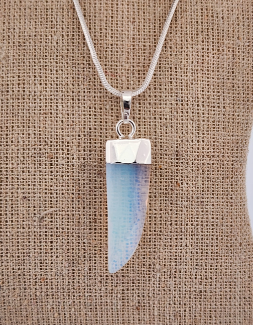 Necklace with a pendant on a textured beige background