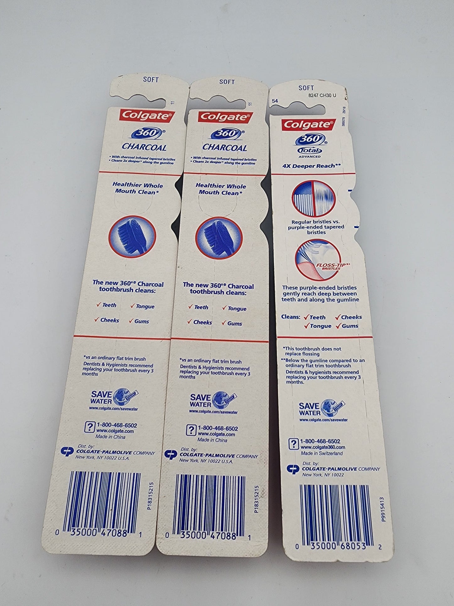 Three Colgate 360 Charcoal toothbrush heads packaging on a gray background