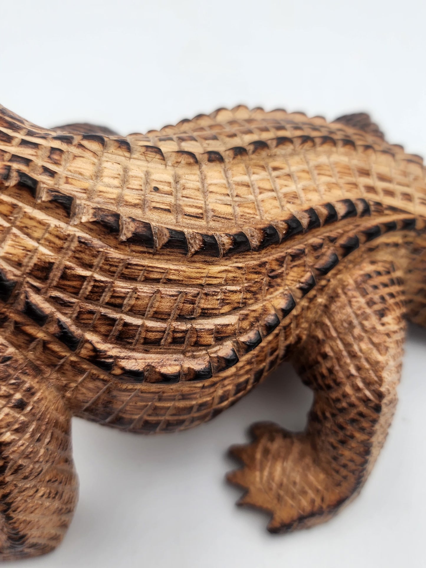 Wooden alligator figurine on a white background