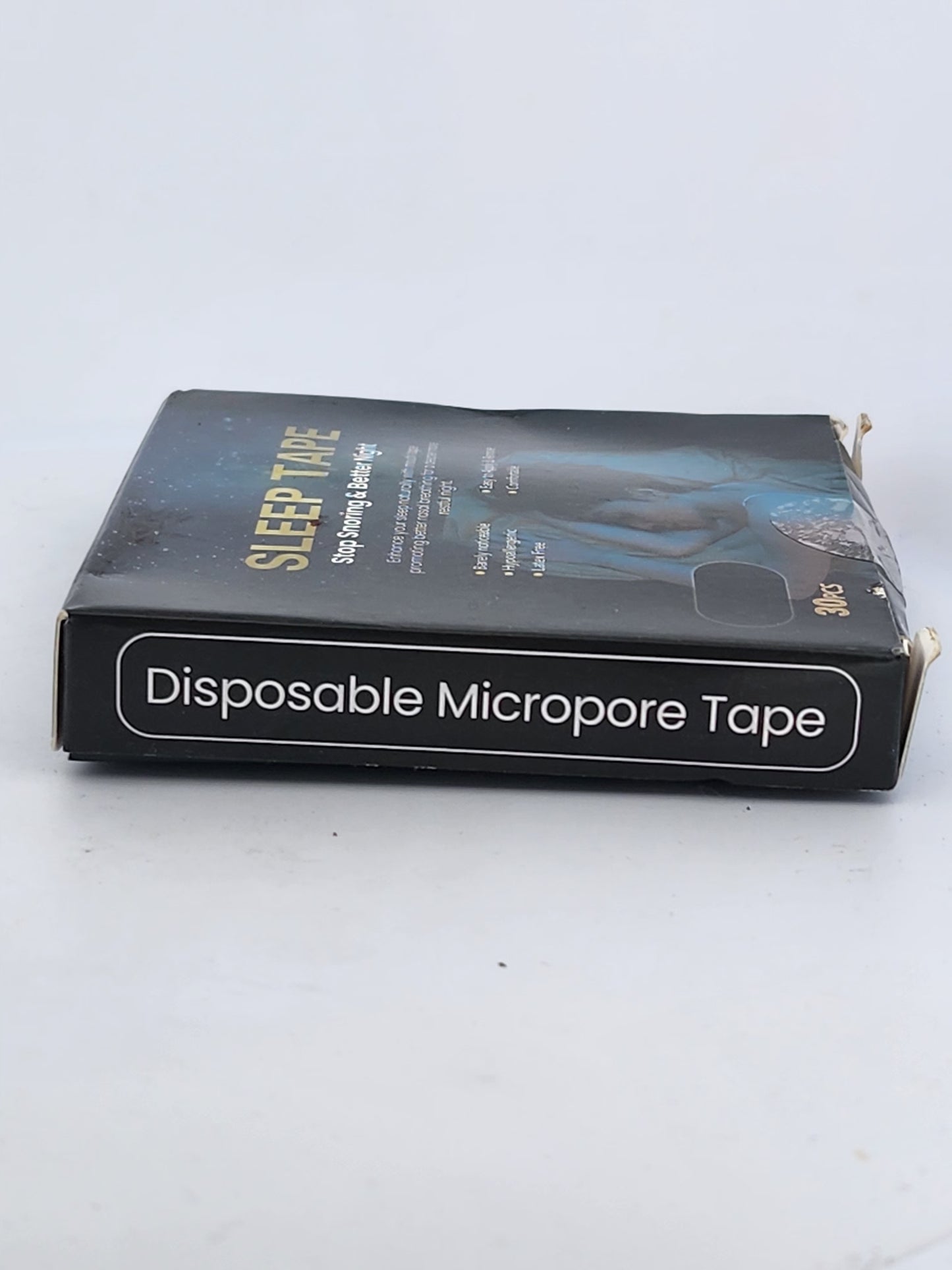 Box of disposable micropore tape with visible branding on a white background