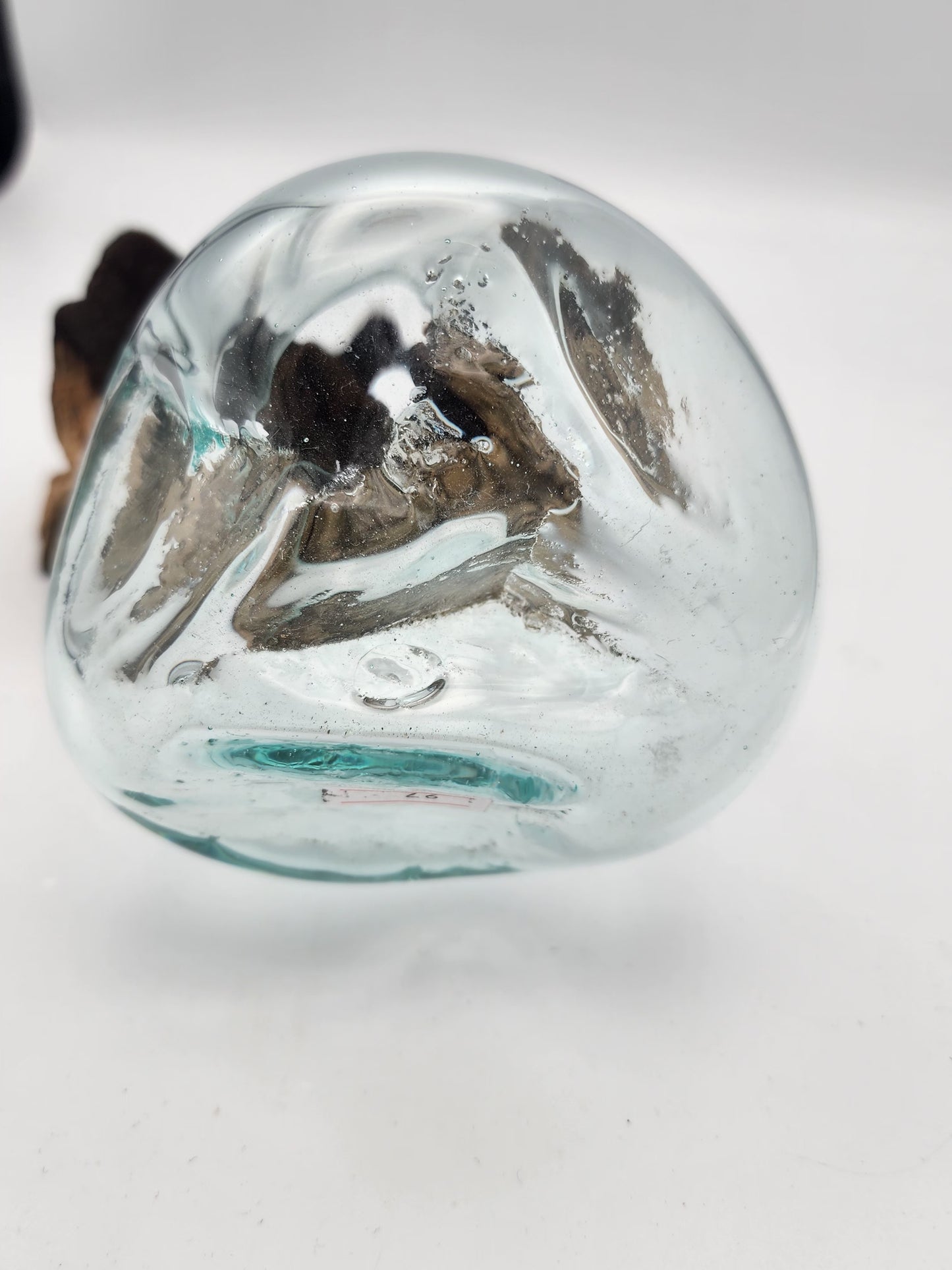 Clear glass sphere with a textured surface on a white background