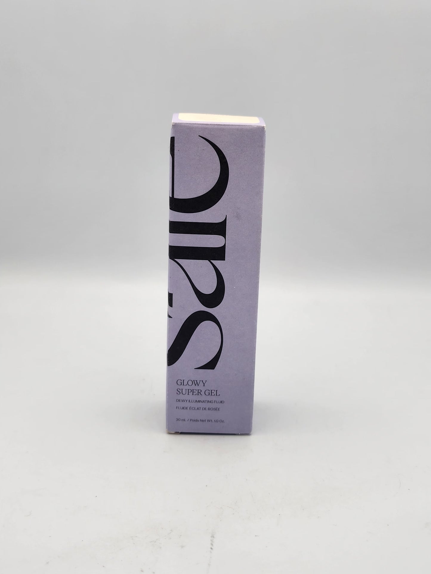 Saie Glowy Super Gel dewy illuminating fluid for skin and body text on purple box