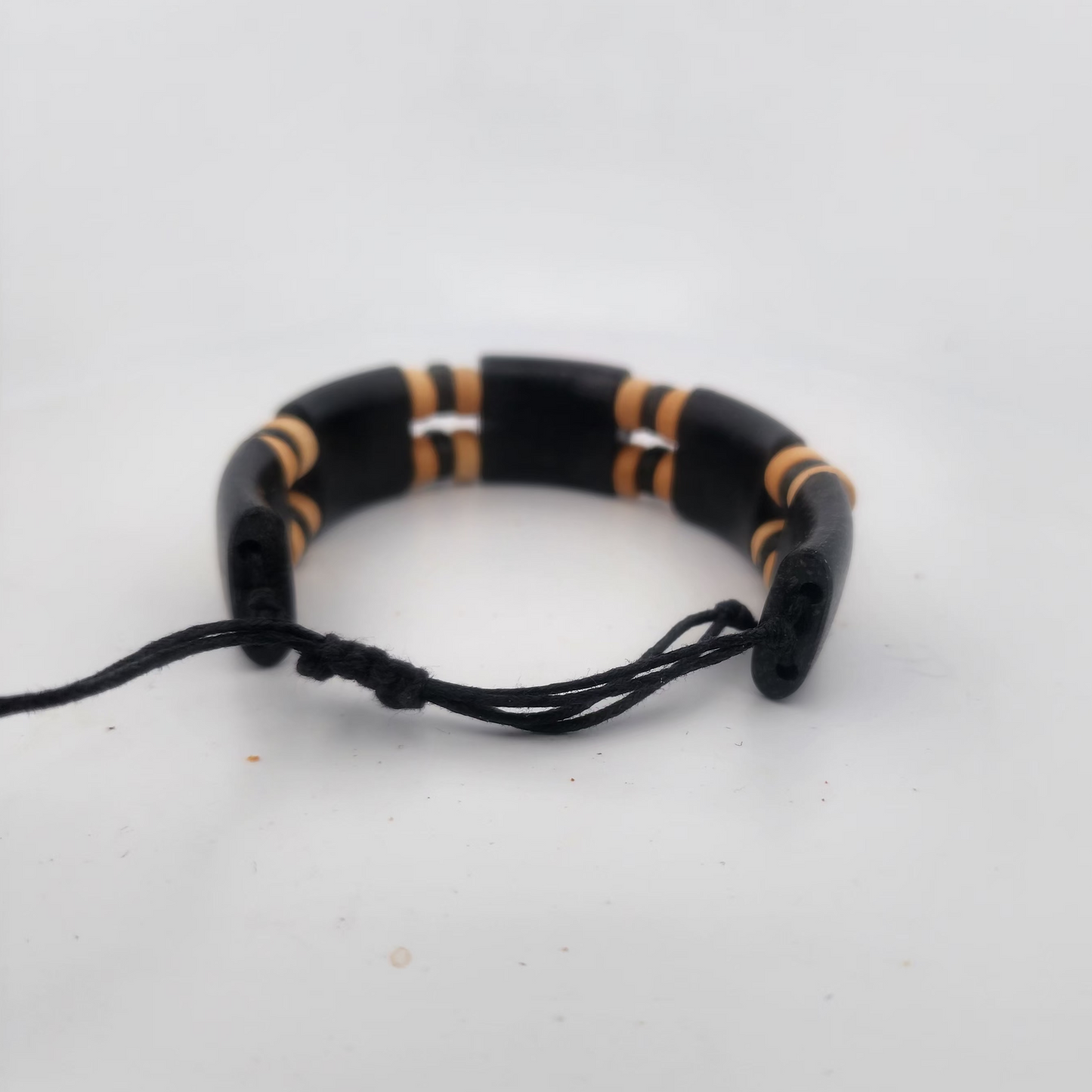 Black and gold beaded bracelet on a white background