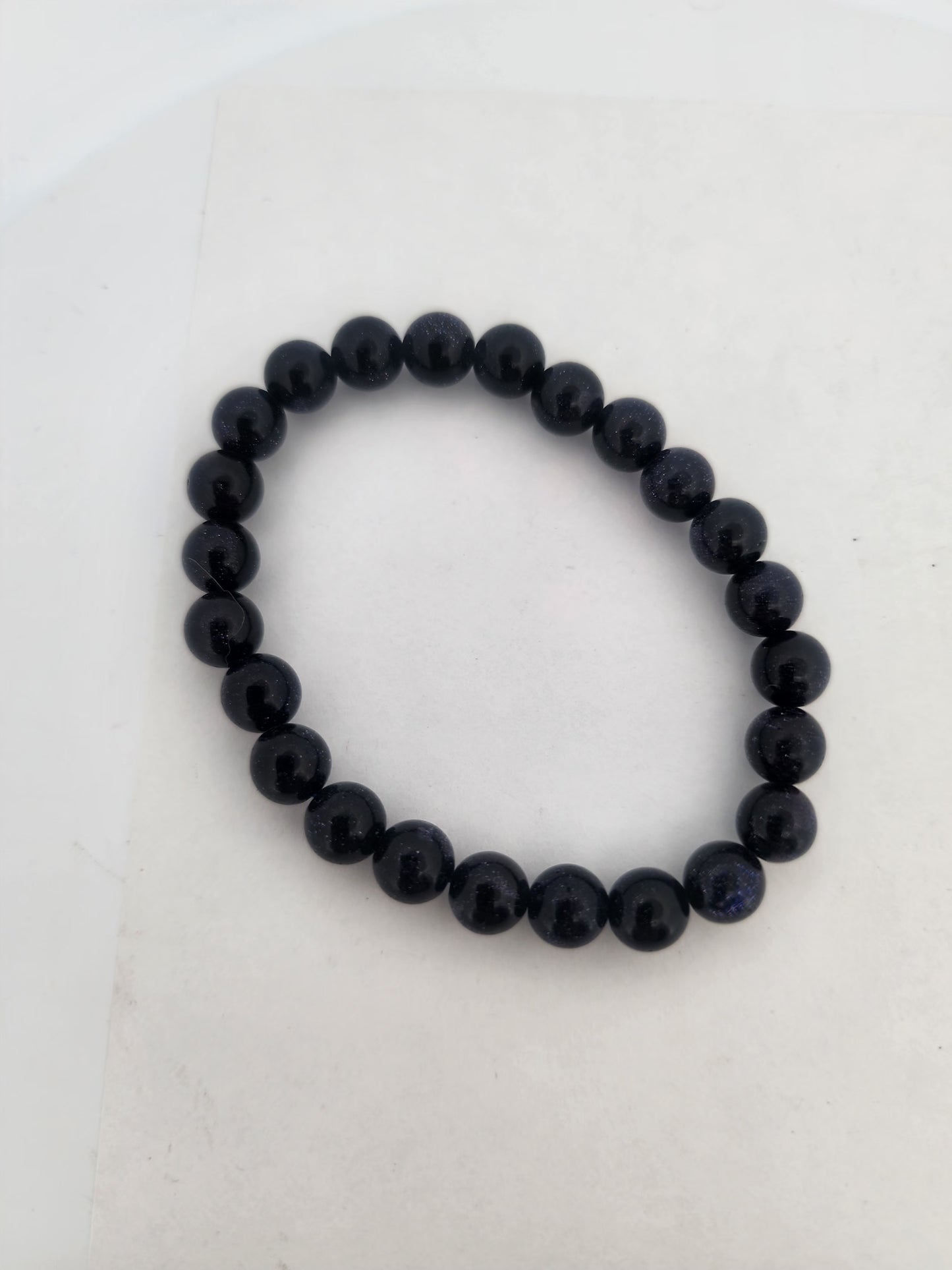 Black beaded bracelet on a white background