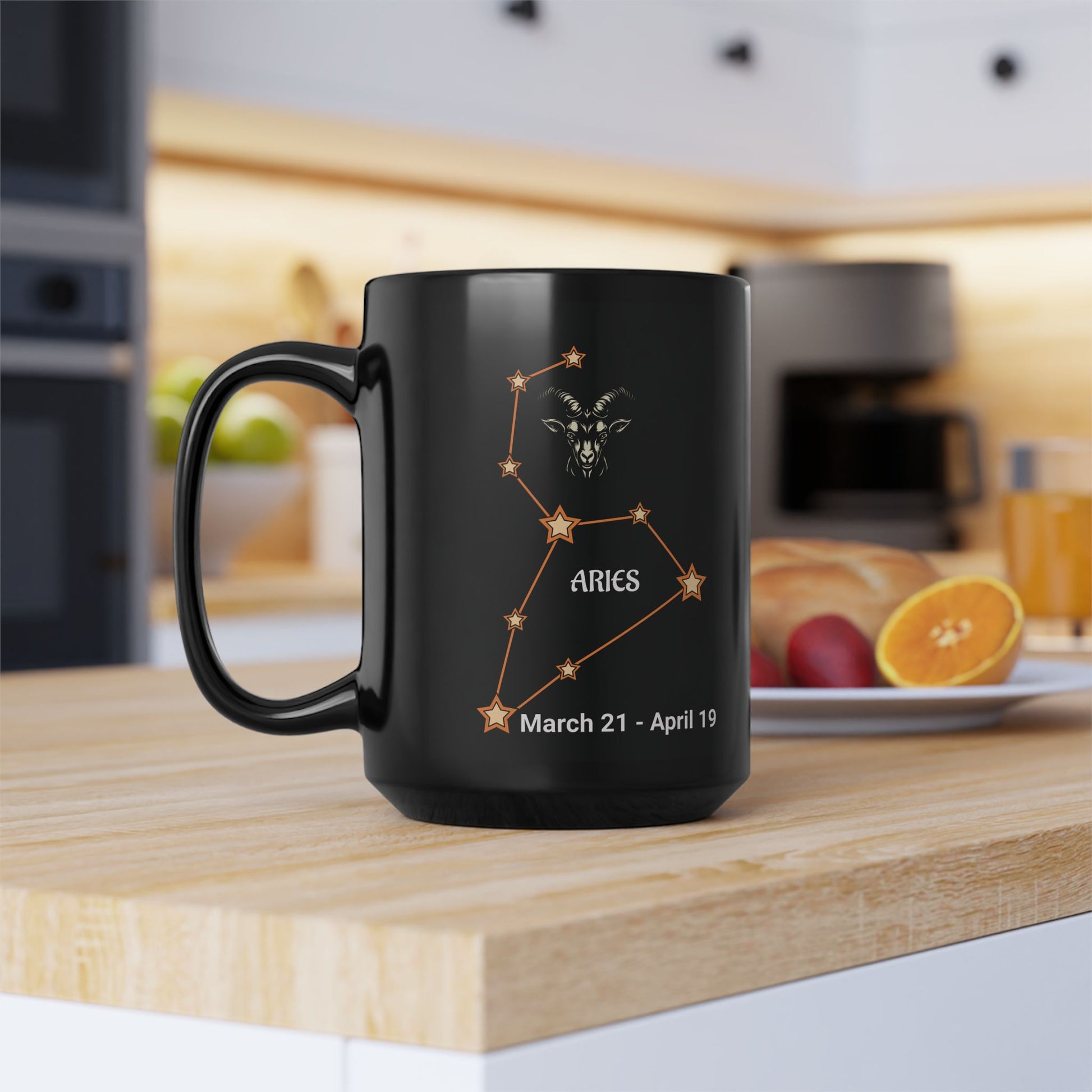 Black mug with Aries constellation design on a kitchen counter