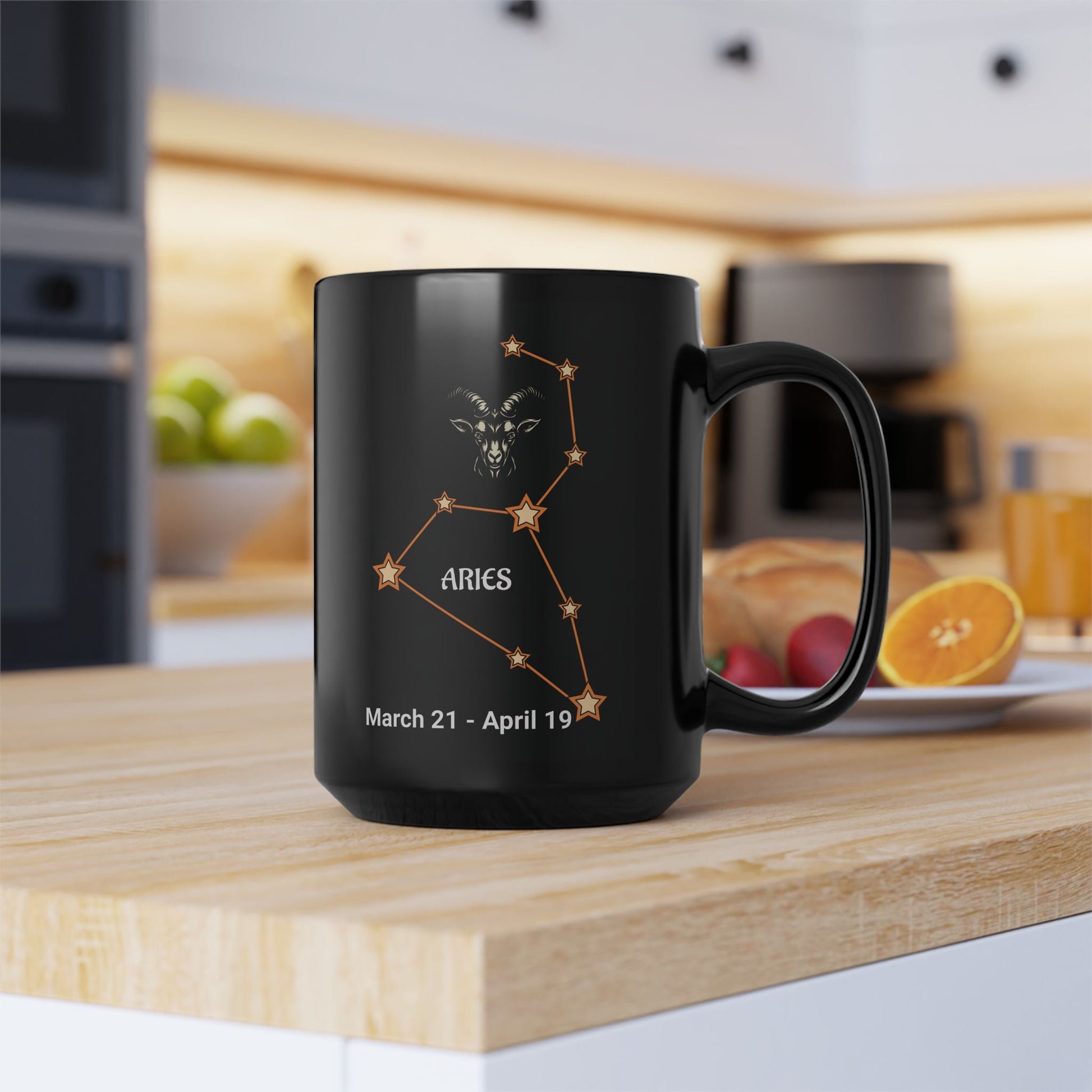 Black mug with Aries constellation design on a kitchen counter