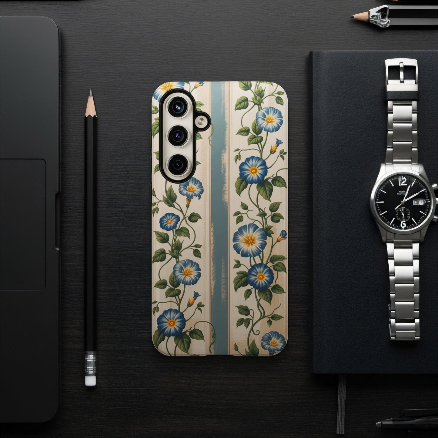 Floral patterned phone case with blue flowers on a wooden background.