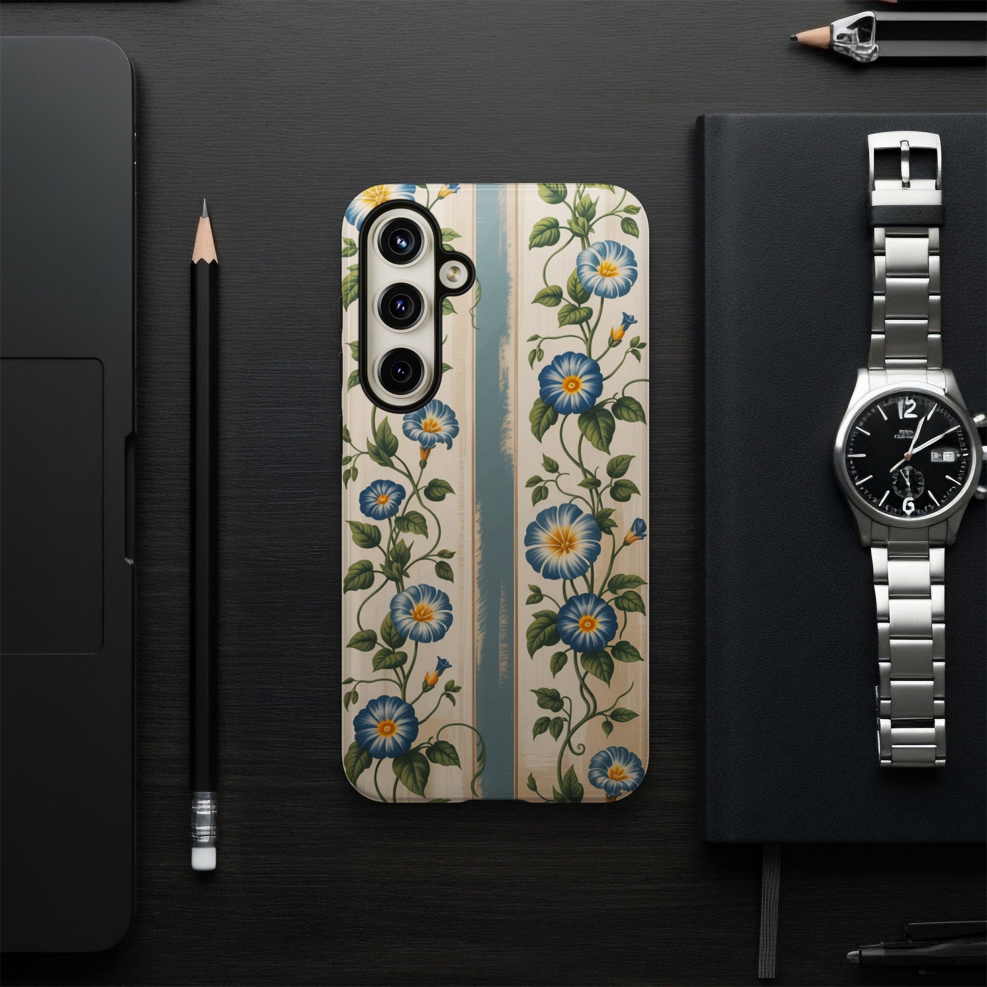Floral patterned phone case with blue flowers on a wooden background.