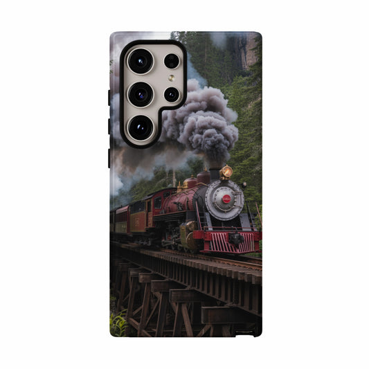 Red steam locomotive with black smoke on wooden railway bridge, forest background.