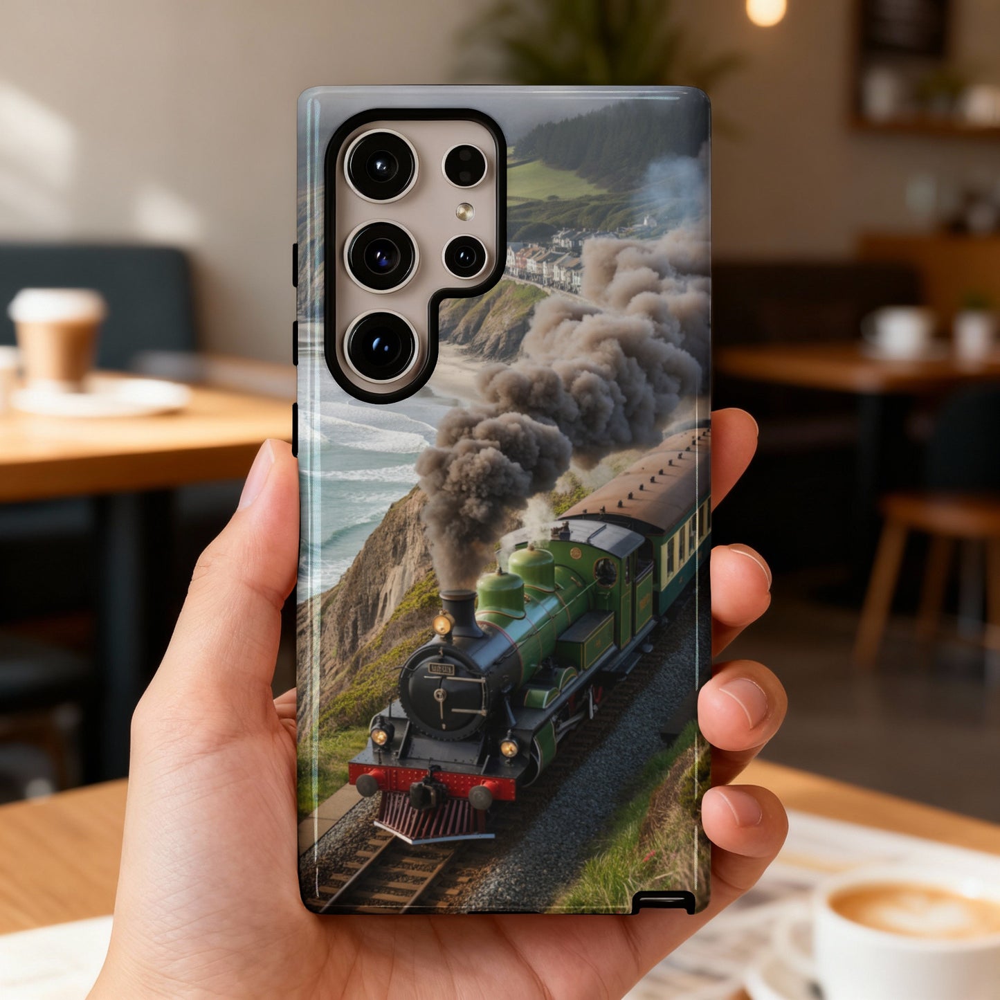 Phone case with vintage green train traveling along a scenic coastal route.