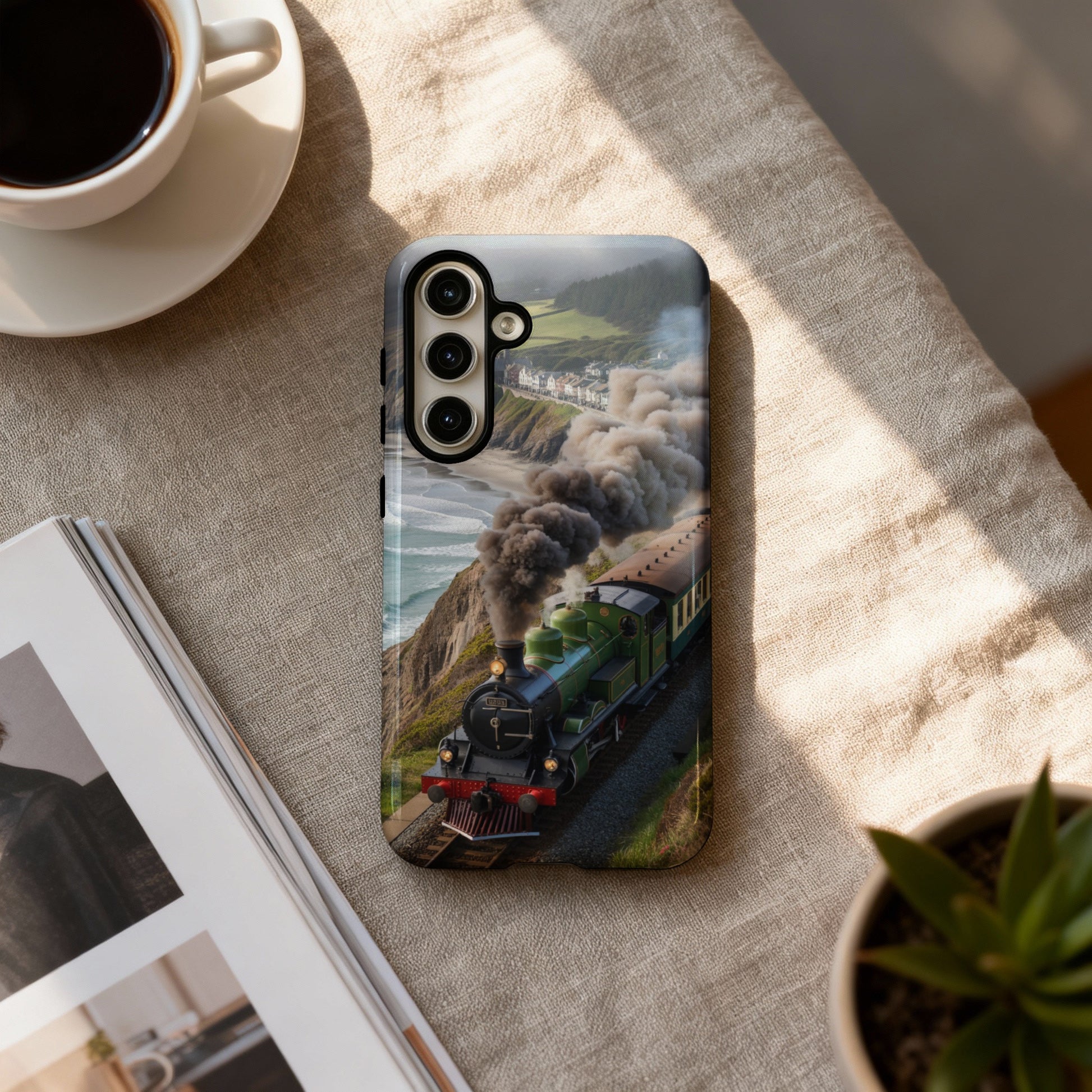 Green steam train on a cliff overlooking the ocean, on a phone case.