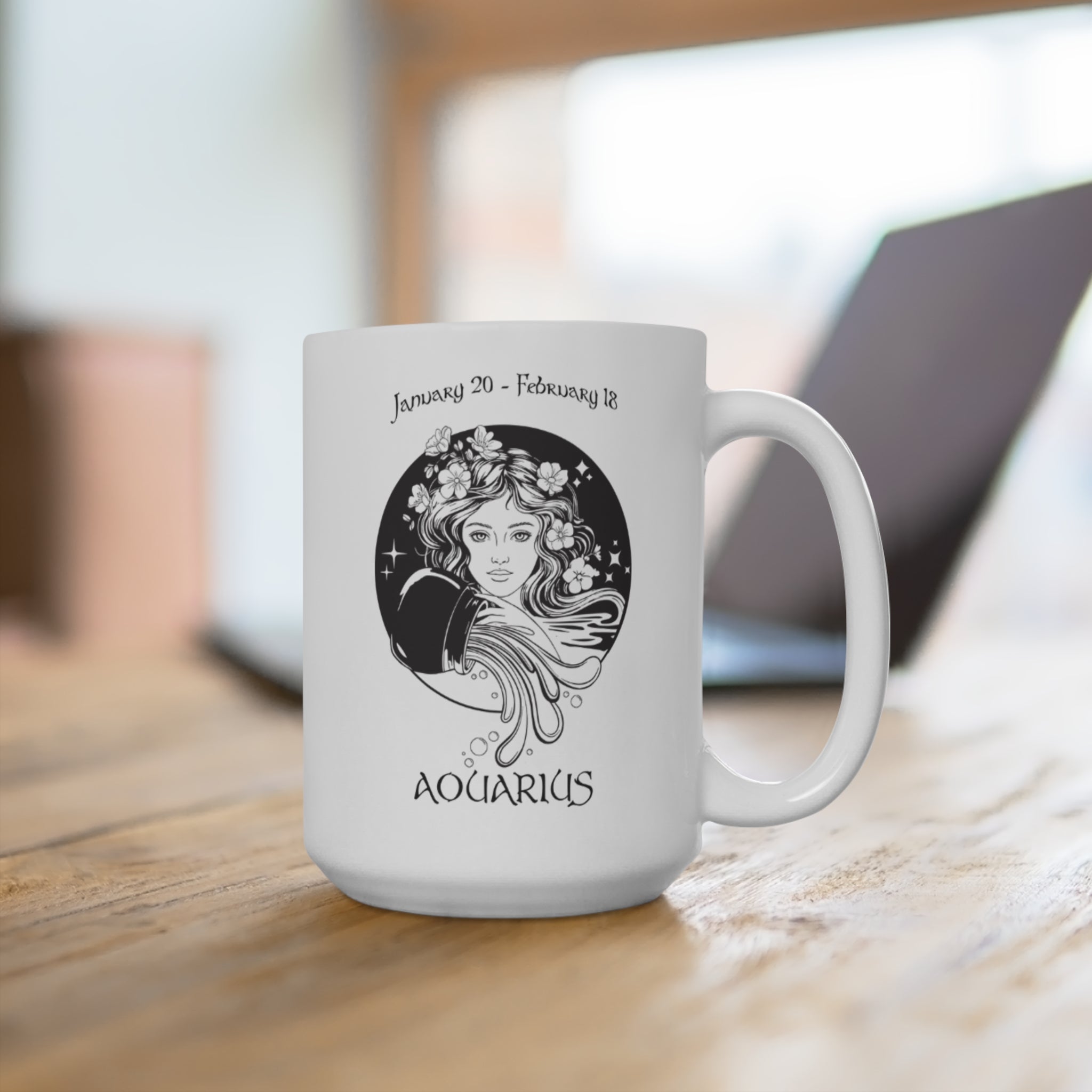 White mug with Aquarius zodiac design on a wooden surface