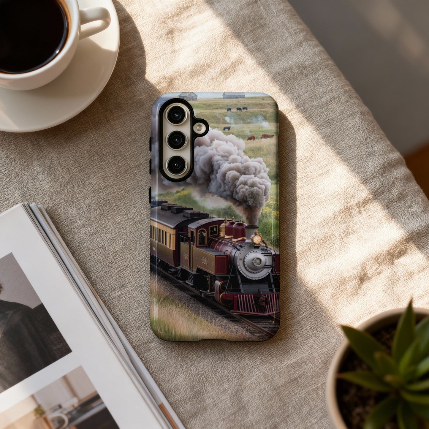 Steam train with cattle in background on phone case.