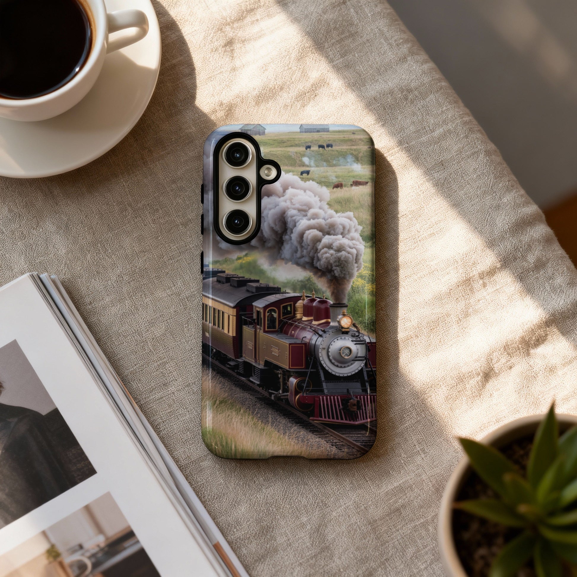 Steam train with cattle in background on phone case.