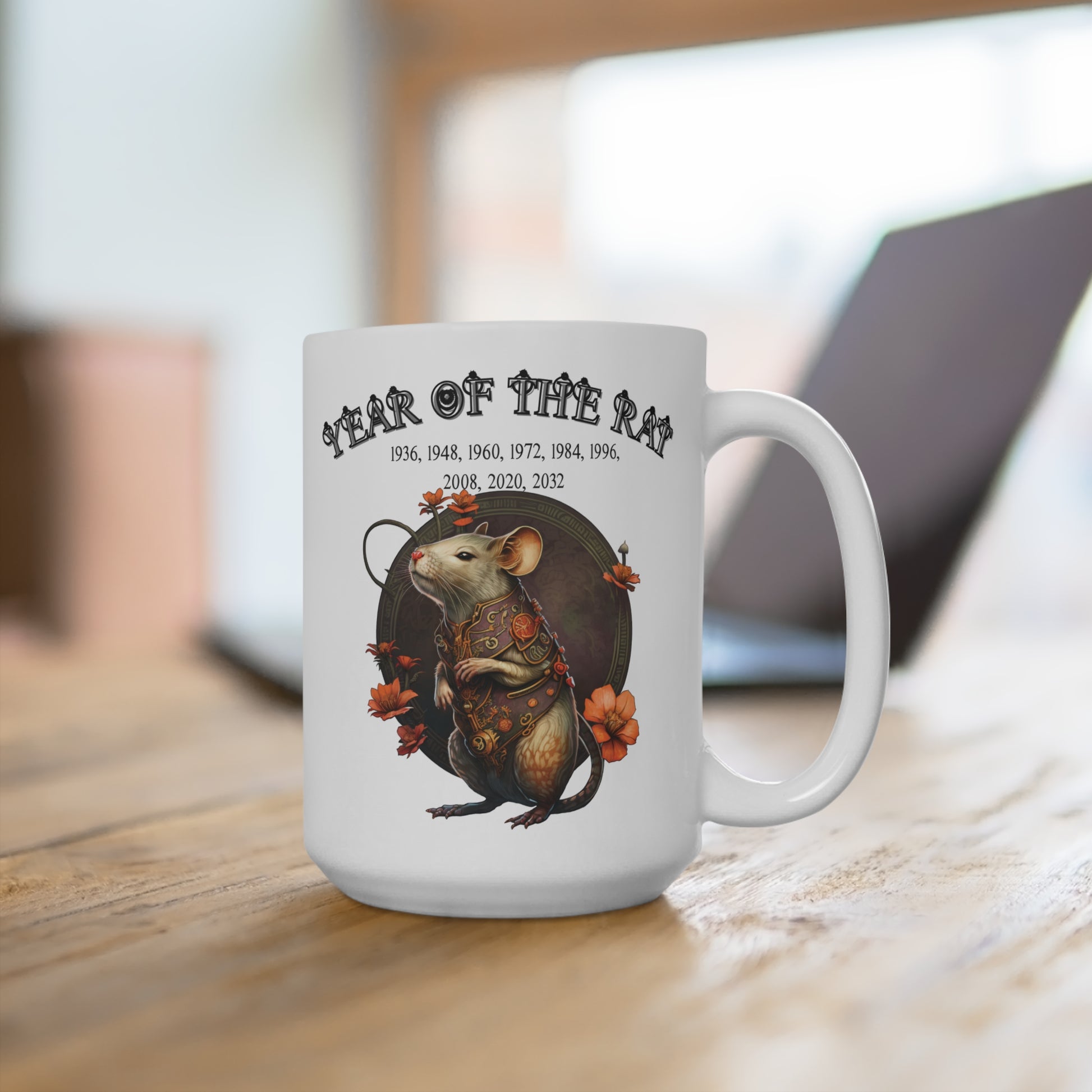 White mug with a design of a rat and text 'Year of the Rat' on a wooden surface.