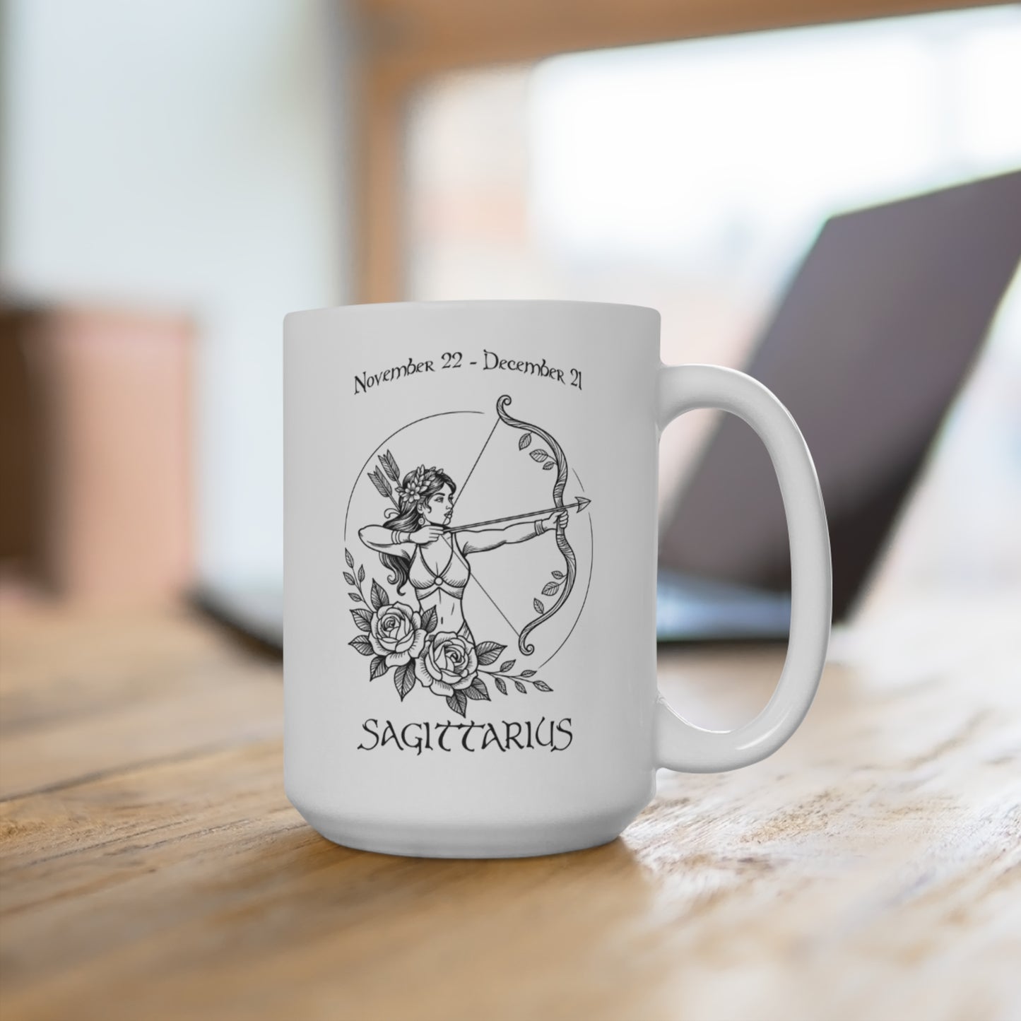 White mug with Sagittarius zodiac design on a wooden surface