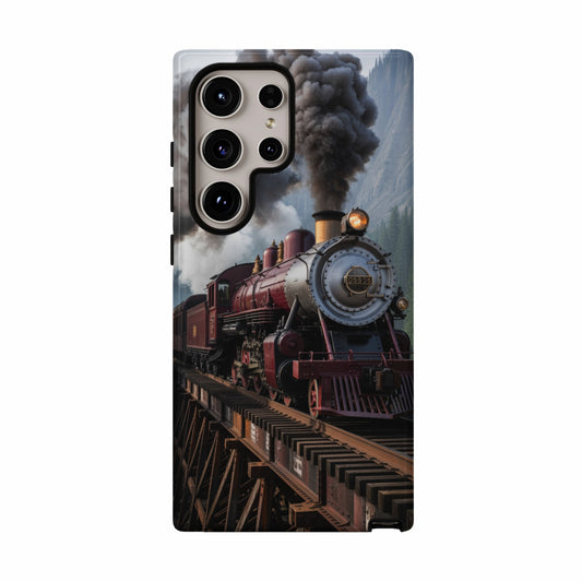 Vintage red steam train crossing a wooden trestle bridge.