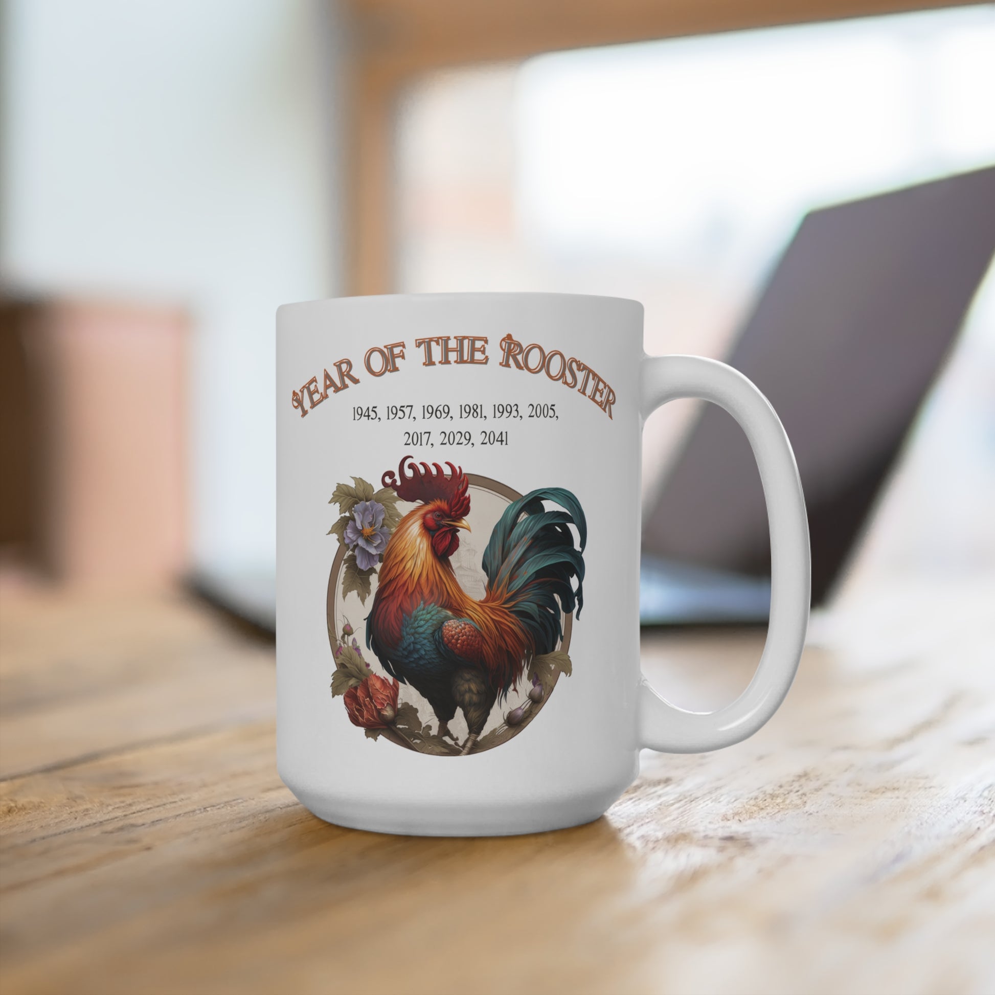 White mug with rooster design and 'Year of the Rooster' text on a wooden surface.