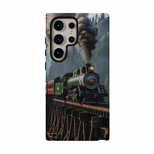 Green steam locomotive pulling red train cars over wooden trestle bridge.