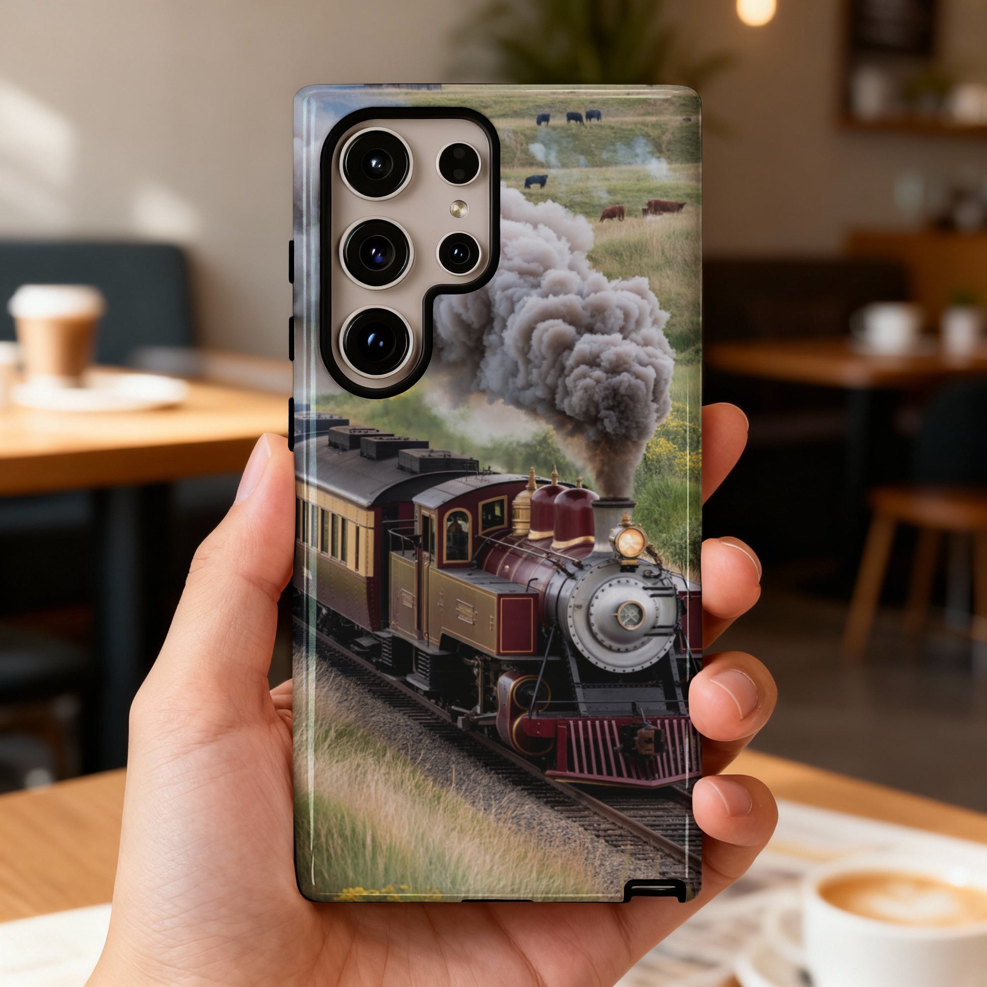 Vintage steam train with smoke billowing, traveling through a grassy field.