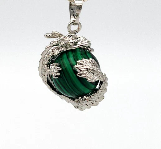 Silver pendant with a green stone on a white background