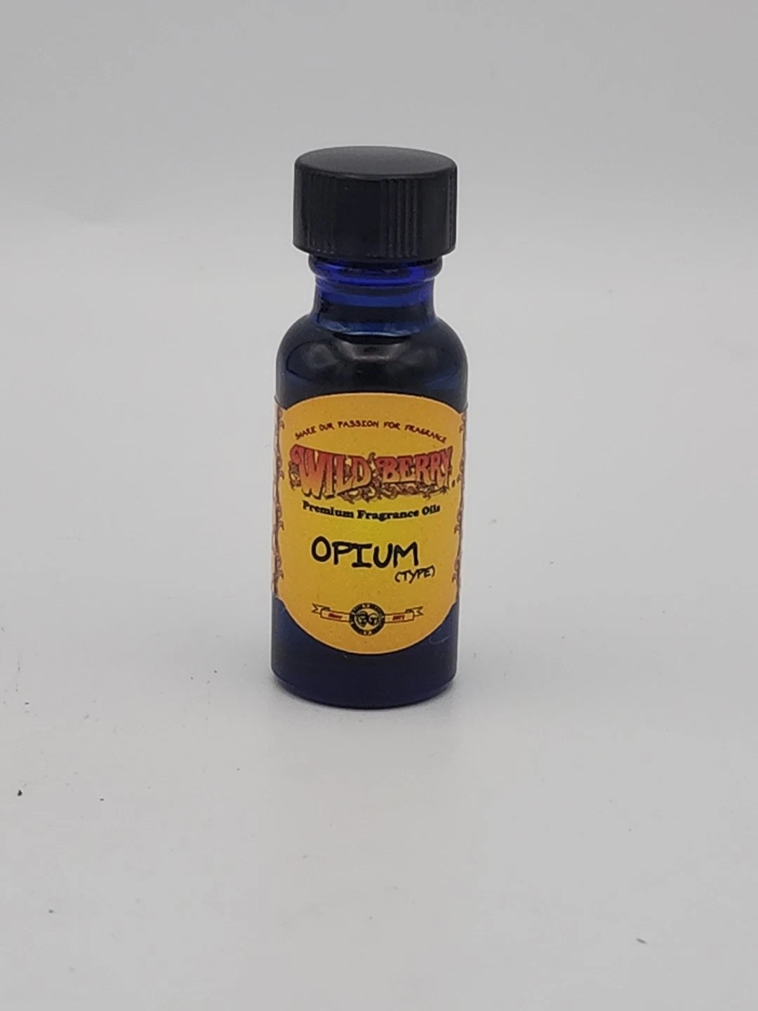 Small bottle of opium fragrance oil with a yellow label on a white background