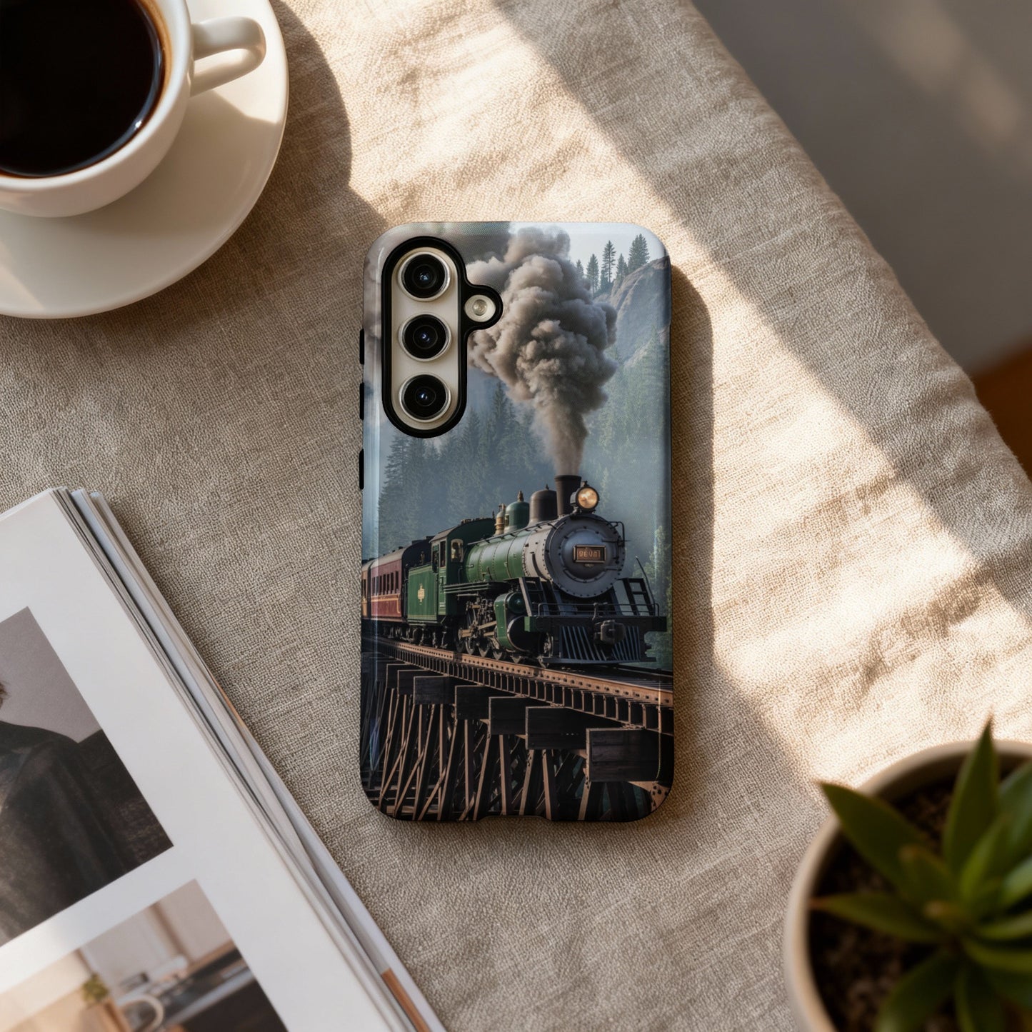 Green steam train crossing a wooden bridge, artwork on phone case.