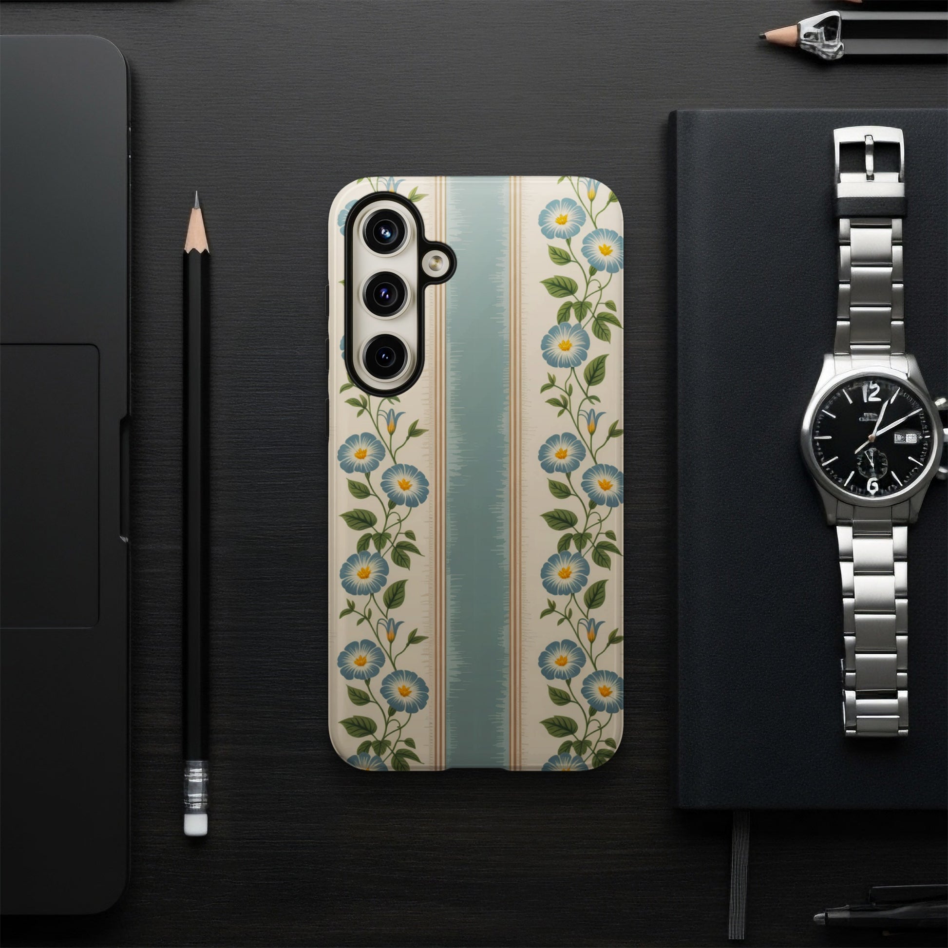 Phone case with blue floral stripe pattern on a dark surface.