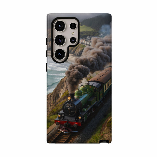 Green steam train travels along a coastal track with smoke billowing.