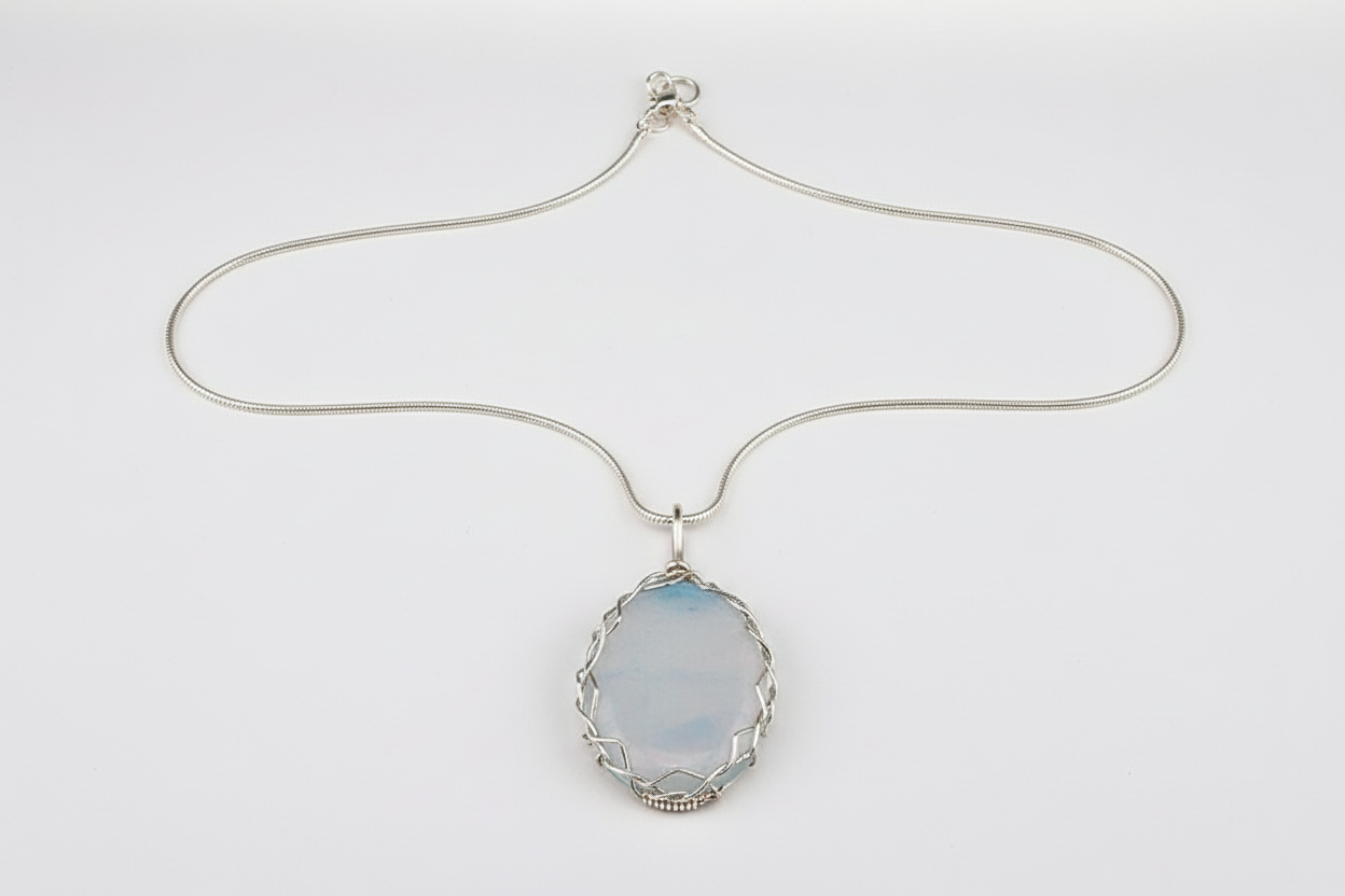 Full view of wire-wrapped opalite pendant necklace with silver chain showing 2.5 by 3 inch ethereal pendant
