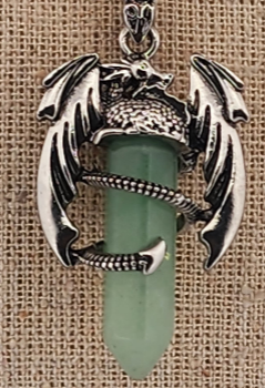 Silver dragon-shaped pendant on a green background