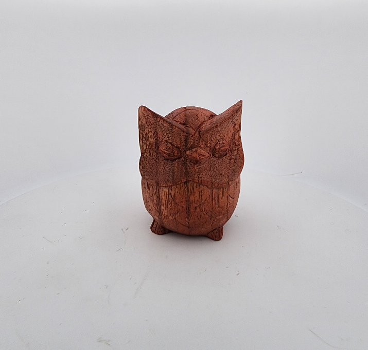 Wooden owl figurine on a white background