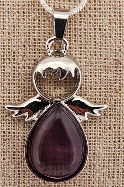 Silver angel pendant with a purple teardrop-shaped stone on a beige fabric background