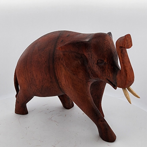 Wooden elephant figurine on a white background