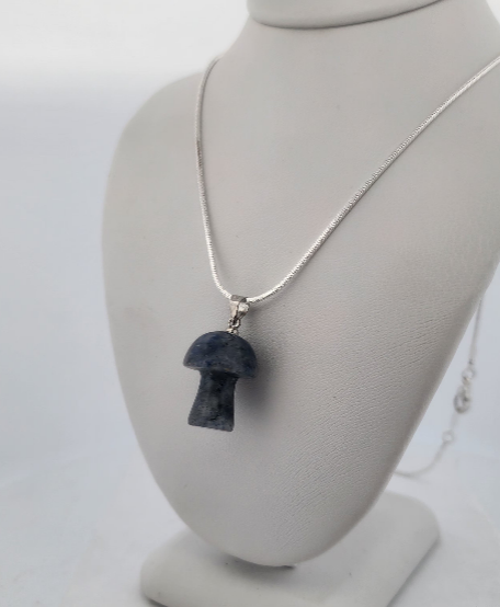 Necklace with a pendant on a gray mannequin bust against a white background