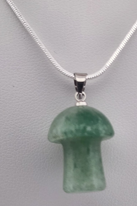 Green mushroom-shaped pendant on a silver chain against a gray background