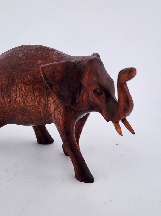 Wooden elephant figurine on a white background
