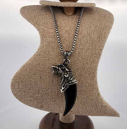 Necklace with a large black dagger pendant on a mannequin bust.