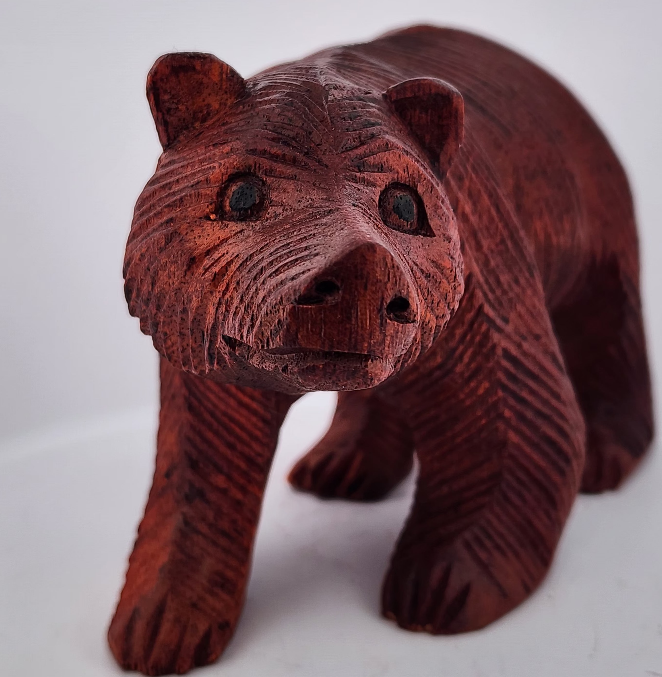 Wooden bear figurine on a white background