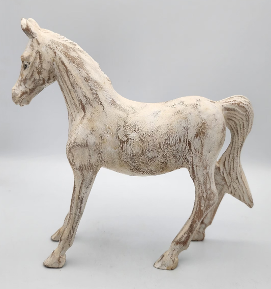 White horse figurine on a gray background