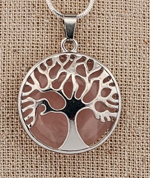 Tree of life pendant on a beige fabric background