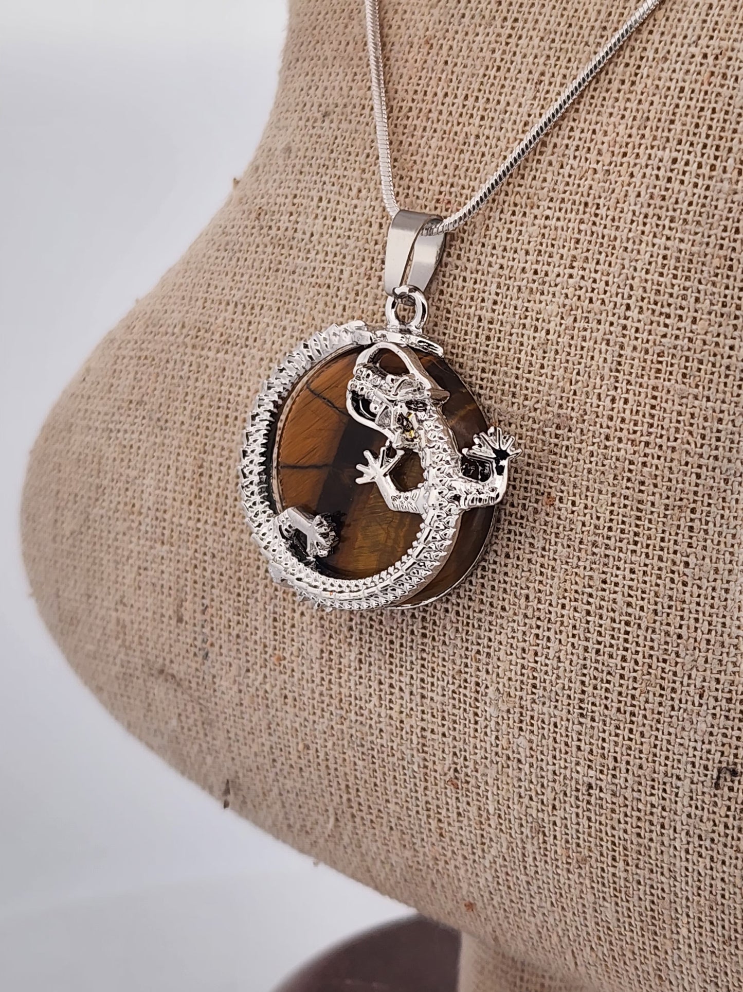 Necklace with a pendant on a mannequin bust against a white background