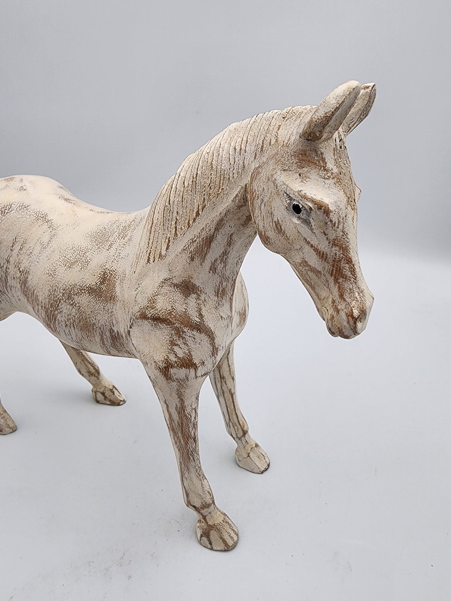 White horse figurine on a light gray background